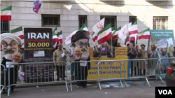 Supporters of the Organization of Iranian American Communities (OIAC) protest Iranian Foreign Minister Mohammad Javad Zarif's appearance at the Council on Foreign Relations in New York, April 23, 2018.