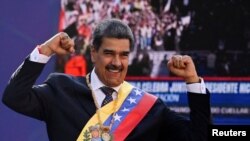 Venezuela's President Nicolas Maduro gestures to supporters after he was sworn in for a third six-year term, in Caracas, Venezuela, Jan. 10, 2025. 