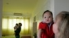FILE - Monica DiGioacchino, right, of Alameda, Calif., holds her new adopted 7-month-old Vietnamese baby Patrick, as her roommate Tracy Sumner, background, of Richmond, Va., also holds her new adopted 5-month-old Vietnamese baby, Hanoi,Vietnam.