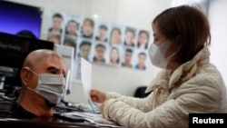 A software engineer works on a facial recognition system that identifies people when they wear a face mask at the development lab of the Chinese electronics manufacturer Hanwang (Hanvon) Technology in Beijing.