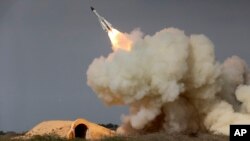 FILE - A long-range S-200 missile is fired in a military drill in the port city of Bushehr, on the northern coast of Persian Gulf, Iran, Dec. 29, 2016. President Donald Trump's national security adviser, Michael Flynn, has said the U.S. is "putting Iran on notice" after it test-fired a ballistic missile.