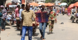 FILE - Somalis without face masks visit the Bakara Market in Mogadishu, Dec. 2, 2020.