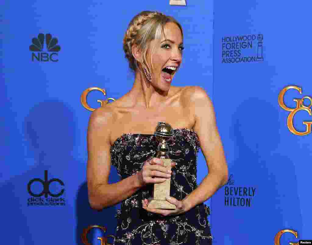 Joanne Froggatt poses with her award for Best Supporting Actress in a series, mini-series or TV Movie for her role in Downton Abbey backstage at the 72nd Golden Globe Awards in Beverly Hills, California, Jan. 11, 2015.