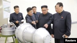FILE - North Korean leader Kim Jong Un, center, provides guidance on a nuclear weapons program in this undated photo released by North Korea's Korean Central News Agency (KCNA) in Pyongyang, Sept. 3, 2017. 