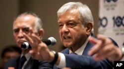 FILE - Mexico's President-elect Andres Manuel Lopez Obrador gives a press conference in Mexico City, July 9, 2018. Lopez Obrador said he and U.S. President Donald Trump spoke Wednesday about ways to ease the migrant crisis.
