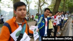 Participants hold hands at a demonstration in Hanoi opposing a plan to cut down around a quarter of the city's trees, March 22, 2105. 