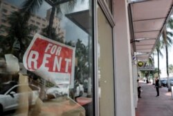 FILE - In this July 13, 2020 file photo, a For Rent sign hangs on a closed shop during the coronavirus pandemic in Miami Beach, Fla.