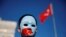 FILE - An ethnic Uighur boy wears a mask during a protest against China in Istanbul, Turkey, Dec. 14, 2019. 