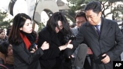 Cho Hyun-ah, center, former vice president of Korean Air Lines, arrives at the Seoul Western District Prosecutors Office in Seoul, South Korea, Tuesday, Dec. 30, 2014.