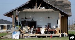 Workers begin repairs to a wall that was lost in the wake of Hurricane Harvey, Aug. 30, 2017, in Rockport, Texas.