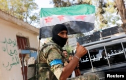 FILE - A member of the Free Syrian Army (FSA) is pictured in the border town of Jarablus, Syria, Aug. 31, 2016. Some analysts say the waning influence in Syria of the staunch anti-Assad FSA was among the factors fueling the U.S. policy shift.