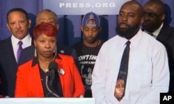In this image from video the parents of Michael Brown, Lesley McSpadden, front left, and Michael Brown Sr., speak at a news conference with civil rights leaders at the National Press Club in Washington, Sept. 25, 2014.