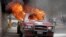 A vehicle that belongs to Radio Tele-Ginen burns during a protest demanding the resignation of President Jovenel Moise in Port-au-Prince, Haiti, June 10, 2019.