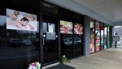 Flowers are seen laid in front of the Young's Asian Massage following the deadly shootings in Acworth, Georgia, March 17, 2021.
