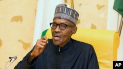 In this photo released by the Nigeria State House, Nigeria President Muhammadu Buhari speaks at the presidential palace upon his arrival from medical vacation in Abuja, Nigeria, March 10, 2017. 
