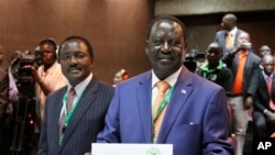 Orange Democratic Party presidential candidate, Raila Odinga (R), displays his registration certificate, with running mate Vice President Kalonzo Musyoka (L), in Nairobi, Kenya, Jan. 30. 2013.