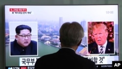 FILE - A man watches a TV screen showing file footage of President Trump, right, and North Korean leader Kim Jong Un at the Seoul Railway Station in Seoul, South Korea, May 16, 2018.
