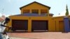 A boy cycles in front of a house in the upmarket Diepkloof extention in Soweto, South Africa, February 2006 file photo. 