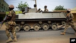 FILE - Nigerian troops patrol in the northeastern Nigeria city of Mubi, 20 kilometers (14 miles) west of the Cameroon border, March 2015.