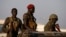 FILE - SPLA soldiers stand in a vehicle in Juba.