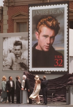 Postal and film industry officials view the unveiling of the new James Dean stamp at a ceremony, June 24, 1996 on the lot where Dean filmed "East of Eden" and "Rebel Without a Cause," at Warner Bros. Studios in Burbank, Calif.