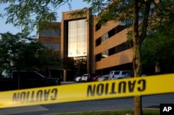 Crime scene tape surrounds a building housing The Capital Gazette newspaper's offices, Friday, June 29, 2018, in Annapolis, Md.