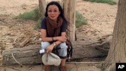 Well-known Tibetan writer Tsering Woeser poses for a photo in Inner Mongolia in northern China, June 23, 2014.