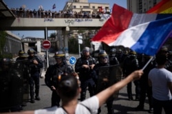 Protesters face French riot police during a demonstration in Marseille, southern France, Saturday, Aug. 14, 2021. Thousands of people, from families to far-right sympathizers, marched in dozens of cities across France for a fifth straight Saturday…