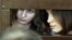 Maria Alekhina, left, and Nadezhda Tolokonnikova, members of punk group Pussy Riot, consult with their lawyers from within their courtroom cage, Moscow, July 30, 2012.