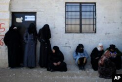 Women standing outside the Free Legal Support Program office in the shelter in Jibreen, Syria, Jan. 21, 2017.