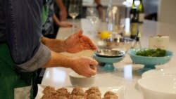 In this photo taken Thursday, April 2, 2020, executive chef Scott Warner, of the Bistro Don Giovanni restaurant, shows how to make Mama Concetta's Meatballs and a salad of fresh greens during a virtual online experience at Bouchaine Vineyards in Napa, Cal