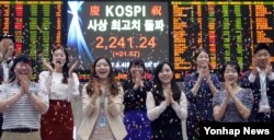 코스피가 사상 최고치인 2,241.24로 장을 마감한 4일 서울 여의도 한국거래소 직원들이 꽃가루를 뿌리며 기념하고 있다.