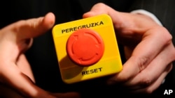 In 2009, U.S. Secretary of State Hillary Clinton gave Russian Foreign Minister Sergei Lavrov a fake 'reset' button during a meeting in Geneva, Switzerland. The red button says "reset" in English and "overload" in Russian. This references the Obama administration's desire to improve ties with Russia. (AP Photo / Fabrice Coffrini Pool)