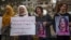 Syrian Kurds demonstrate outside a UN building, calling on authorities to help release young girls they say were abducted and recruited into fighting, in the northeast city of Qamishli on Nov. 28, 2021. 