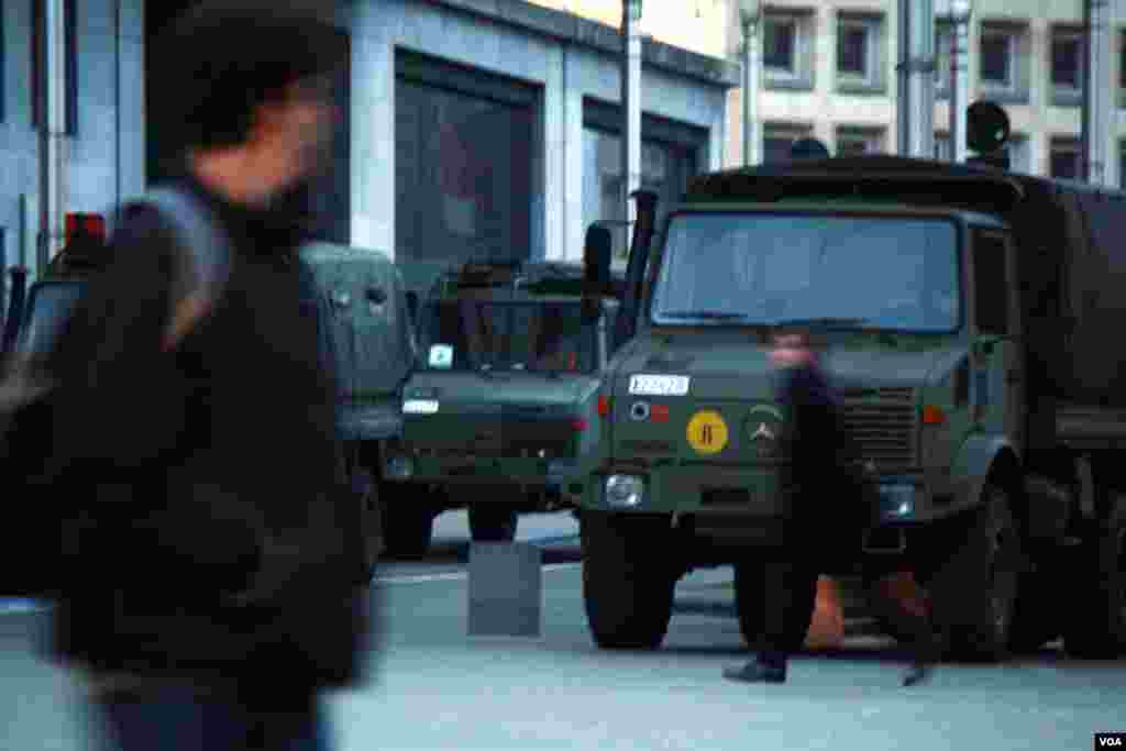 Outside Brussels’ central train station, commuters hurry toward their homes as the military guards the area, March 24, 2016. (H. Murdock/VOA)