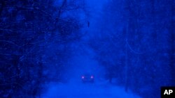 A motorist drives through a snowstorm in Durham, Maine, Dec. 29, 2016. A nor'easter brought heavy snow to parts of Maine — more than 2 feet in some towns.
