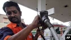 FILE - Man fills up with diesel at a fuel station in Kolkata.