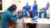 A man has a swab sample taken for a coronavirus disease antigen test at a cultural center in the working-class neighborhood of Vallecas in Madrid, Spain, Oct. 1, 2020. 