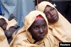 FILE - Some of the newly-released Dapchi schoolgirls are pictured in Jumbam village, Yobe State, Nigeria, March 21, 2018.