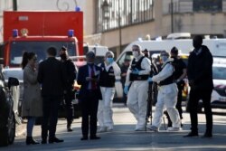 Police officers secure the area where an attacker stabbed a female police worker, in Rambouillet, near Paris, France, April 23, 2021.