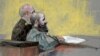 In this courtroom sketch, Maj. Nidal Hasan, right, appears at the Lawrence William Judicial Center during the sentencing phase of his trial, Aug. 27, 2013, in Fort Hood, Texas. 