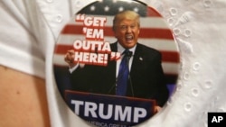 FILE - A supporter of Republican presidential candidate Donald Trump wears a campaign button before the start of a rally in Spokane, Wash., May 7, 2016.