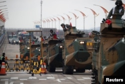 FILE - Amphibious assault vehicles of the South Korean Marine Corps travel during a military exercise as a part of the annual joint military training called Foal Eagle between South Korea and the U.S. in Pohang, South Korea, April 5, 2018.