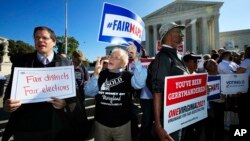 Protesters join others in a rally for fair elections, outside the U.S. Supreme Court in Washington, Oct. 3, 2017.