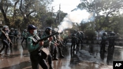 Bangladeshi policemen fire tear gas shells to disperse protestors demanding cancellation of a plan for a massive coal-fired power plant near ecologically sensitive mangrove forests on the coast in Dhaka, Bangladesh, Jan. 26, 2017.