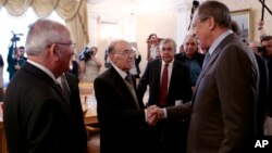 Russian Foreign Minister Sergey Lavrov, right, shakes hands with members of the Syrian delegation prior to a meeting with Qadri Jamil, former deputy prime minister representing Syria's opposition Popular Front of Change and Liberation, in Moscow, Aug. 31, 2015.