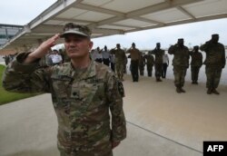 US soldiers salute during a grand opening ceremony, June 29, 2018, of the new headquarters building for the United Nations Command and US Forces Korea at Camp Humphreys in Pyeongtaek.