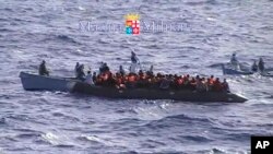 Migrants receive help from the Italian Navy off the Sicilian island of Lampedusa Oct.12, 2013.