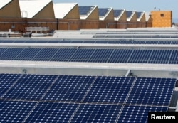 FILE - Solar panels sit on the roof of SunPower Corporation in Richmond, California, March 18, 2010.