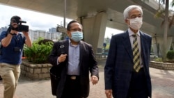 Pro-democracy lawmaker Martin Lee, center, and Albert Ho arrive at a court in Hong Kong Thursday, April 1, 2021. (AP Photo/Vincent Yu)